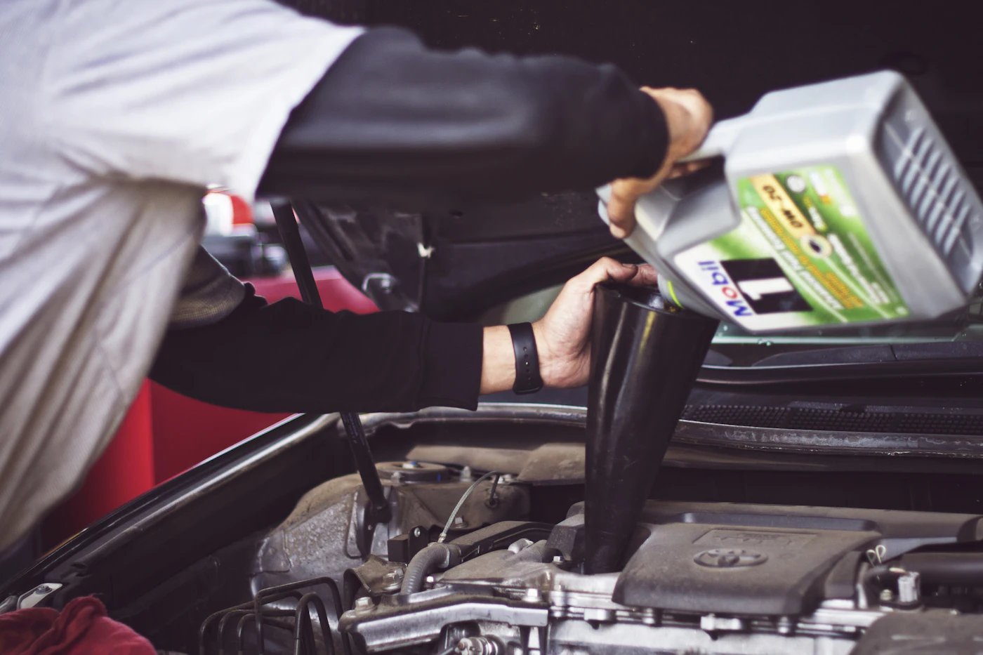 Fresh oil being poured into an engine